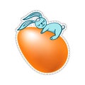 Easter blue bunny with an orange egg on a white background. Isolate clip art sticker rabbit hugs an egg.