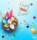 Easter blue card, eggs in the nest, bunny ears, brushes and paints