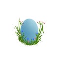 Easter blue egg hidden in the grass and flowers.