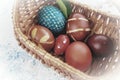 Easter boiled eggs of different colors dyed with onion peel and paint in wicker basket. Vegetable patterns on the shell Royalty Free Stock Photo