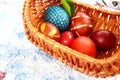 Easter boiled eggs of different colors dyed with onion peel and paint in wicker basket. Vegetable patterns on the shell Royalty Free Stock Photo