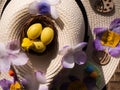 Easter bonnet straw hat decorated with eggs and flowers Royalty Free Stock Photo