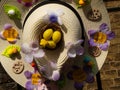 Easter bonnet straw hat decorated with eggs and flowers Royalty Free Stock Photo