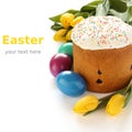 Easter bread, colorful eggs and yellow tulips on white background (with sample text) Royalty Free Stock Photo