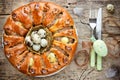 Easter bread ring stuffed with minced meat and quail eggs on old Royalty Free Stock Photo