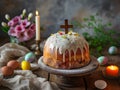 Easter bread with a wooden cross on the background of a candle and pink, spring flowers. Royalty Free Stock Photo