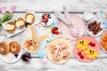 Easter breakfast or brunch table scene. Above view on a white wood background. Royalty Free Stock Photo