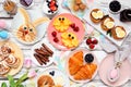 Easter breakfast or brunch table scene. Top view on a white wood background. Royalty Free Stock Photo