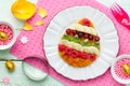 Easter breakfast idea - pancakes shaped colorful Easter egg with Royalty Free Stock Photo