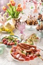 Easter breakfast with a platter of ham and sausage salad and stuffed eggs on festive table Royalty Free Stock Photo