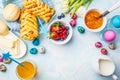 Easter Breakfast table. Colored eggs, buns, juice and jam. Blue background, top view, food frame Royalty Free Stock Photo