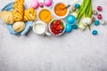 Easter Breakfast table, top view. Colored eggs, flowers, buns, milk, juice and jam, white background Royalty Free Stock Photo