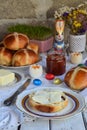 Easter breakfast with traditional hot cross buns, jam, butter and egg. Holiday still life. Festive table place setting decoration Royalty Free Stock Photo