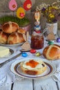 Easter breakfast with traditional hot cross buns, jam, butter and egg. Holiday still life. Festive table place setting decoration Royalty Free Stock Photo