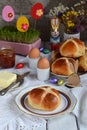 Easter breakfast with traditional hot cross buns, jam, butter and egg. Holiday still life. Festive table place setting decoration Royalty Free Stock Photo