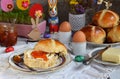 Easter breakfast with traditional hot cross buns, jam, butter and egg. Holiday still life. Festive table place setting decoration Royalty Free Stock Photo