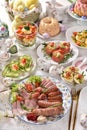 Easter breakfast with traditional sausage and cold cuts, deviled eggs and salads on festive table Royalty Free Stock Photo