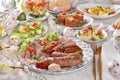Easter breakfast with traditional sausage and cold cuts, deviled eggs and salads on festive table Royalty Free Stock Photo
