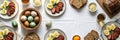 Easter brunch table with painted eggs, sliced bread, and sausage platters Royalty Free Stock Photo