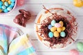 Easter bundt cake with chocolate nest of candy eggs. Top view table scene. Royalty Free Stock Photo