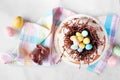 Easter bundt cake with chocolate nest of candy eggs. Top view table scene. Royalty Free Stock Photo