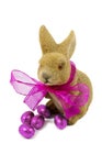 Easter bunnie with pink bow and Easter eggs. Royalty Free Stock Photo