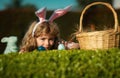 Easter bunny child hunting eggs outdoors Happy Easter day, Kid boy laying on grass in park.