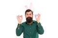 Easter bunny colored eggs. Holiday accessories. Celebration of spring holiday. Bearded man with bunny ears and Easter