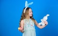 The Easter bunny is coming. Easter bunny rabbit. Little girl and rabbit toy. Small girl in rabbit ears with Easter toy