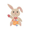 Easter bunny. A cute rabbit in cartoon style is sitting with a basket of Easter eggs. Funny bunny with colorful Easter Royalty Free Stock Photo