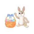 Easter bunny. A cute rabbit in cartoon style is sitting with a basket of Easter eggs. Funny bunny with colorful Easter Royalty Free Stock Photo