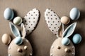 Easter Bunny ears from napkins and eggs. Quail and chicken eggs. Gray textile background. Happy easter