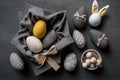 Easter Bunny ears from napkins and eggs. Quail and chicken eggs. Gray textile background. Happy easter