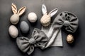 Easter Bunny ears from napkins and eggs. Quail and chicken eggs. Gray textile background. Happy easter