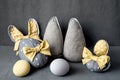 Easter Bunny ears from napkins and eggs. Quail and chicken eggs. Gray textile background. Happy easter