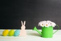 Easter bunny and eggs with daisies bouquet Royalty Free Stock Photo