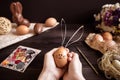 Easter bunny. Female hands holding easter egg on the wooden table