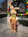 Easter bunny in front of an easter fountain Royalty Free Stock Photo