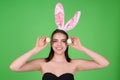 Easter bunny girl wear easter fluffy bunny ears hold easter eggs, isolated studio background. Eater portrait of female