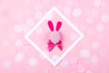 Easter bunny with confetti on pink background.