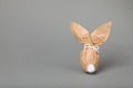 Easter bunny made of kraft paper and egg on grey background. Space for text