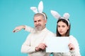 Easter bunny man and woman hold board board for text. Royalty Free Stock Photo