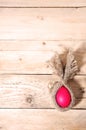 Easter bunny minimalist flat red chicken egg wrapped in burlap creative rabbit lies on a natural wooden background, top view, Royalty Free Stock Photo