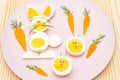 Easter bunny rabbit and chicken eggs children kids food concept. With carrot on rosy pink plate Royalty Free Stock Photo