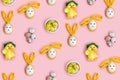 Easter Bunny rabbit and cute little chicken, colorful quail egg on pink background. Easter pattern Royalty Free Stock Photo