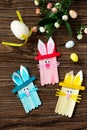 Easter bunny toy gift stics puppets on wooden table. Handmade. Project of children`s creativity, handicrafts. Royalty Free Stock Photo