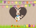 Easter Bunny wish you Happy Easter with eggs and carrots behind fence on hearth shape hole - text on flags