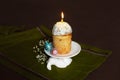 Easter cake with burning candles with colored eggs on a stand in the form of a hare