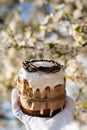 Easter cake and colored eggs on a plate, white gloves, a festive composition in a rustic style