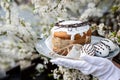 Easter cake and colored eggs on a plate, white gloves, a festive composition in a rustic style